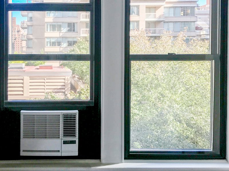 Indow window insert installed around an a/c unit to block air pollution and increase air flow