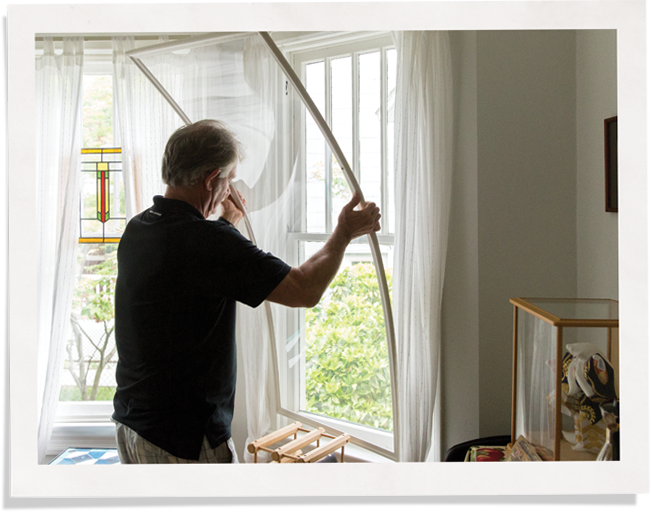 Customer measuring custom storm window inserts.