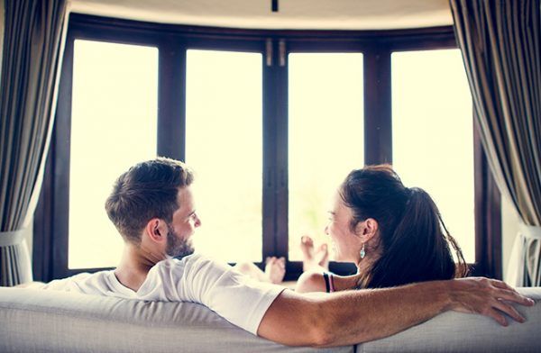 Couple in front of window: window energy efficiency myths debunked