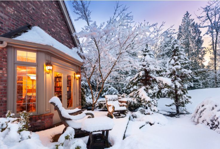 snow covered home kept warm because of winterized windows