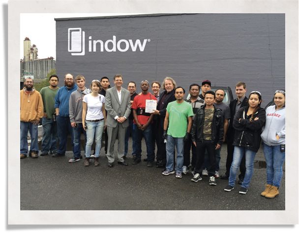 group of individuals outside a building: Indow clean practice in manufacturing