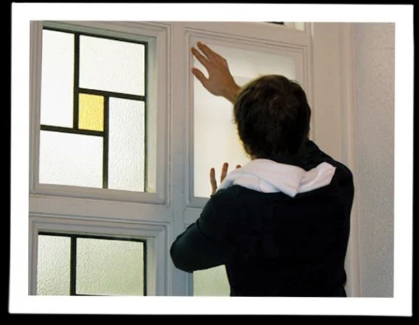 person installing indow window church storm windows