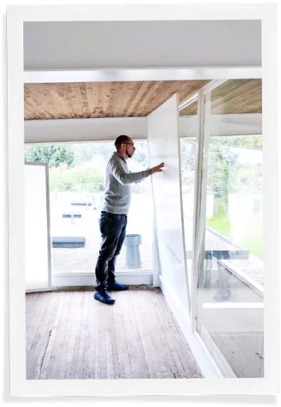 Man installing window insulation inserts.