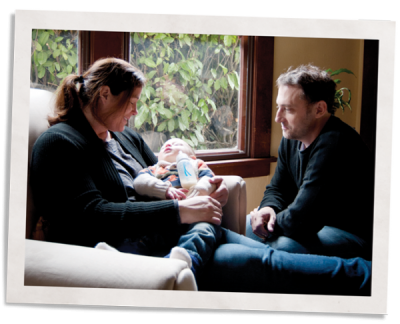 woman and man feeding their newborn next to soundproofing window inserts to reduce noise pollution