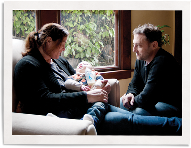 family next to window with Indow inserts used for traffic noise reduction