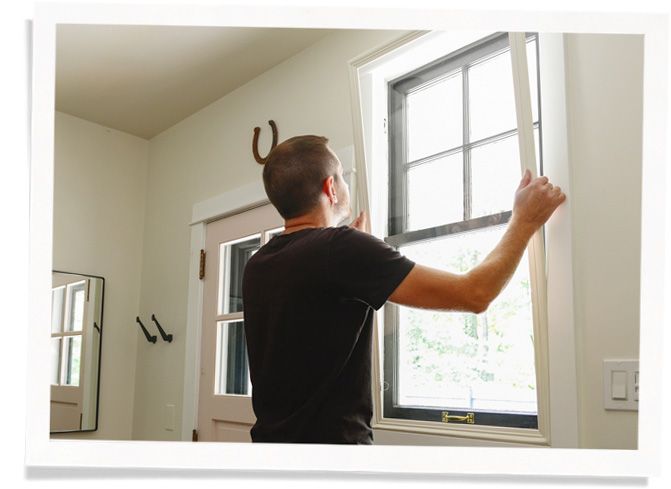 man installing window insert to block noise without blocking natural light