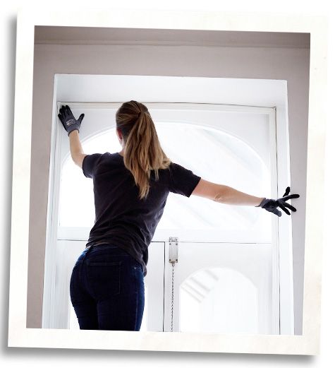 woman installing Indow insert for higher stc rated windows